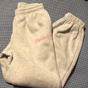 Edikted women’s Light Gray Sweatpants with Pink Script Logo